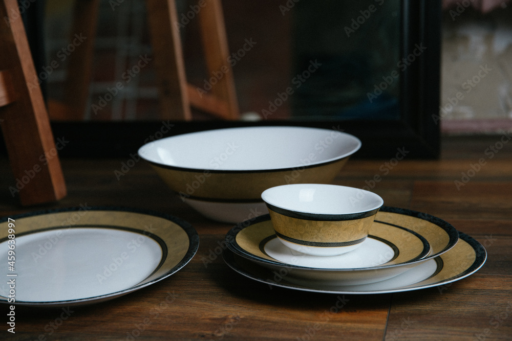 empty dishes, a set of artist's tableware with a beautiful ornament on a wooden table, exquisite tableware empty dishes, a set of artist's tableware with a beautiful ornament on a wooden table, exquisite tableware