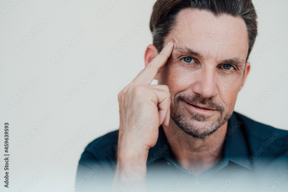 Mature male professional with hair stubble in office Mature male professional with hair stubble in office