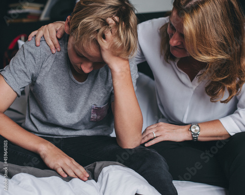 Mother consoling her upset son