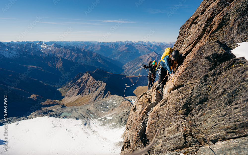 Rock climber on Studlgrat ridge on Grossglockner, highest mountain in Austria. Concept of alpine rock climbing.
