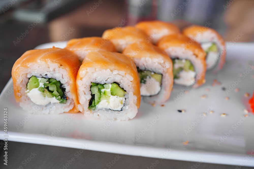 a set of Philadelphia rolls on a white plate. Japanese cuisine. 