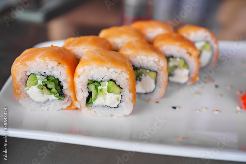 a set of Philadelphia rolls on a white plate. Japanese cuisine. 