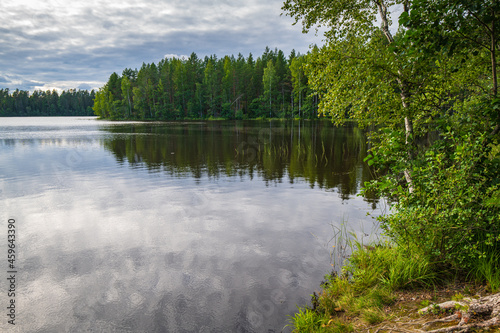 Fototapeta Naklejka Na Ścianę i Meble -  Beautiful landscape of the lake with the reflection of the forest in the water.