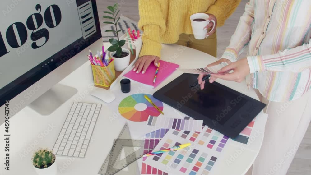 Graphic designers discussing project in office