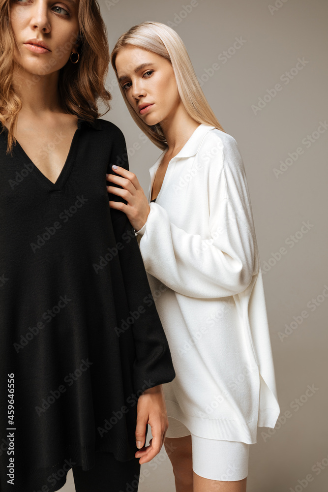 Studio photoshoot of a smiling young women wearing casual clothing against a brown background. Natural makeup and hairstyle Studio photoshoot of a smiling young women wearing casual clothing against a brown background. Natural makeup and hairstyle