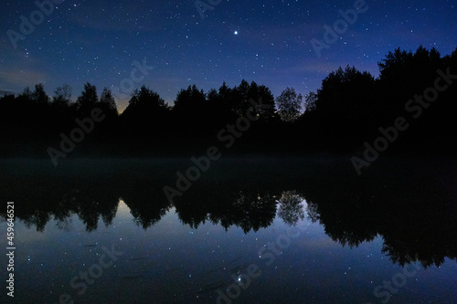 Fog on the river on a starry night in the forest. Dubna river, Moscow region, Russia.