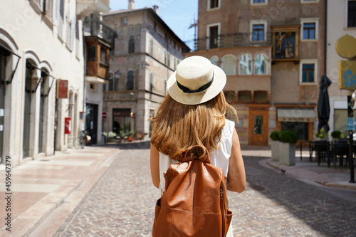 Traveler backpacker girl walking in historic city street