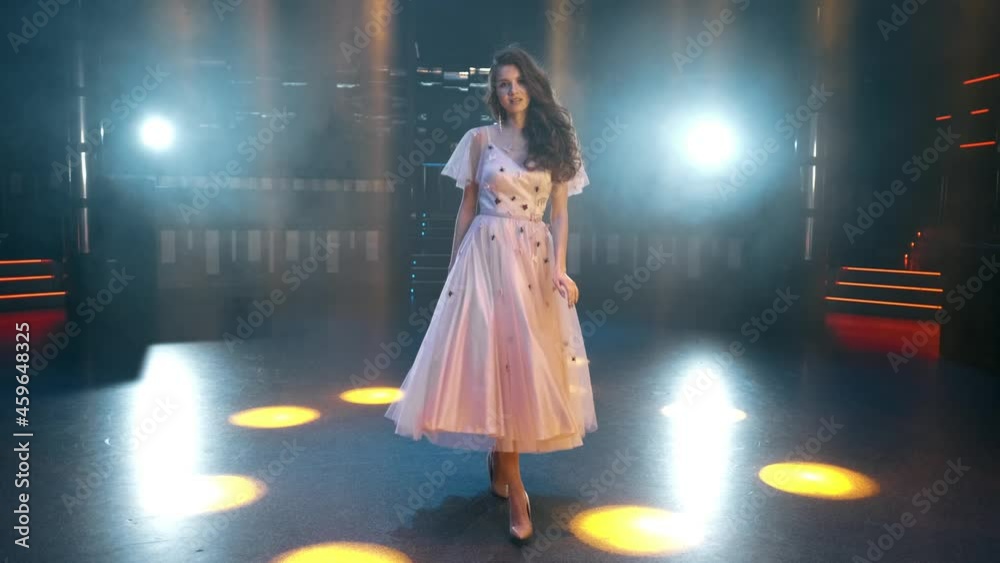 Sexy, sensual and seductive woman with long hair posing in dress at the night club. 4K slow motion shot Sexy, sensual and seductive woman with long hair posing in dress at the night club. 4K slow motion shot
