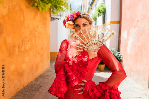 Female flamenco artist standing with hand on hip at alley photo