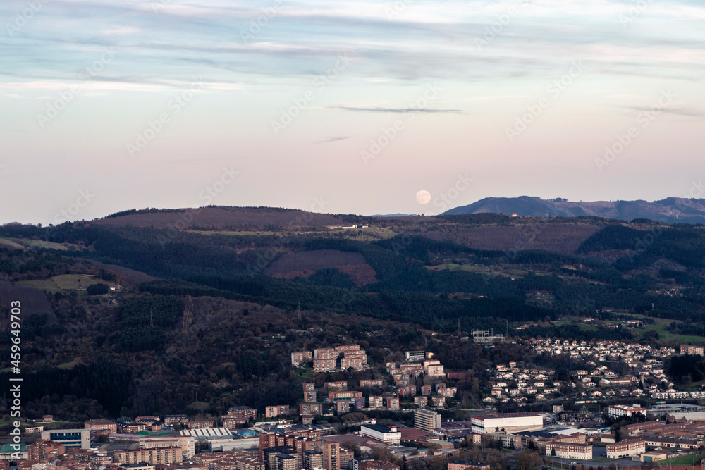 panoramic view of bilbao at sunset from mount malmasin with full moon panoramic view of bilbao at sunset from mount malmasin with full moon