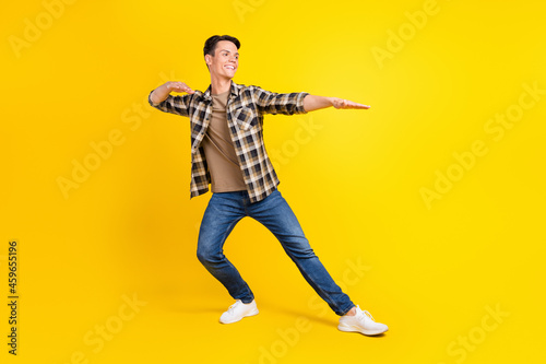 Profile photo of crazy dancer guy enjoy disco wear checkered shirt jeans footwear isolated yellow color background
