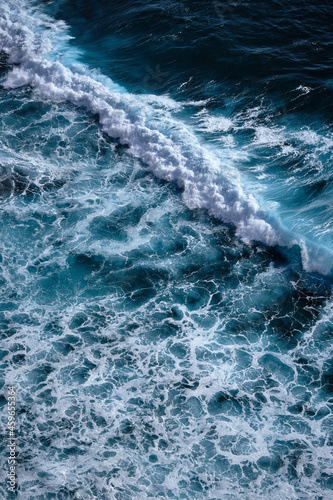 Aerial view to seething waves with foam. Waves of the sea meet each other during high tide and low tide