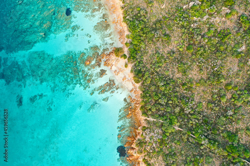 View from above, stunning aerial view of a green and rocky coastline bathed by a turquoise, crystal clear water. Liscia Ruja, Costa Smeralda, Sardinia, Italy.. © Travel Wild