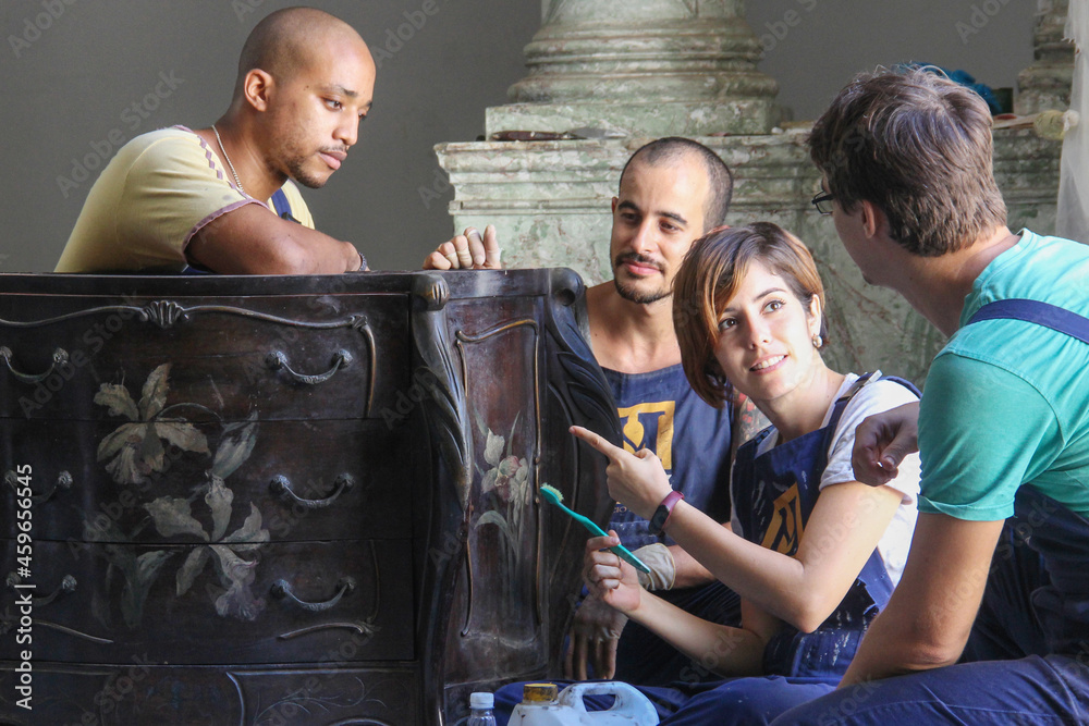 Ταπετσαρία Group of people restoring a piece of wooden vintage furniture