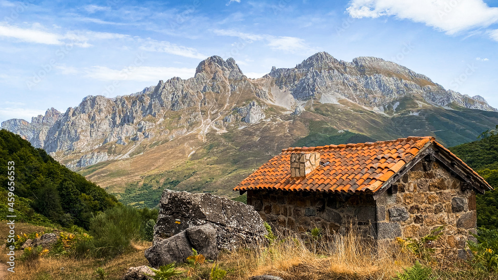 Mountain cabin with high and beautiful mountains in the background. Majada de Brez, Picos de Europa