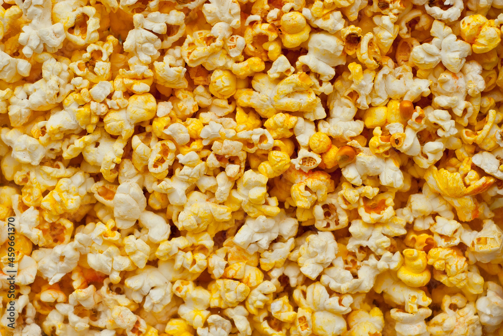 Lots of popcorn on the pile. Texture of yellow popcorn close up. Lots of popcorn on the pile. Texture of yellow popcorn close up.