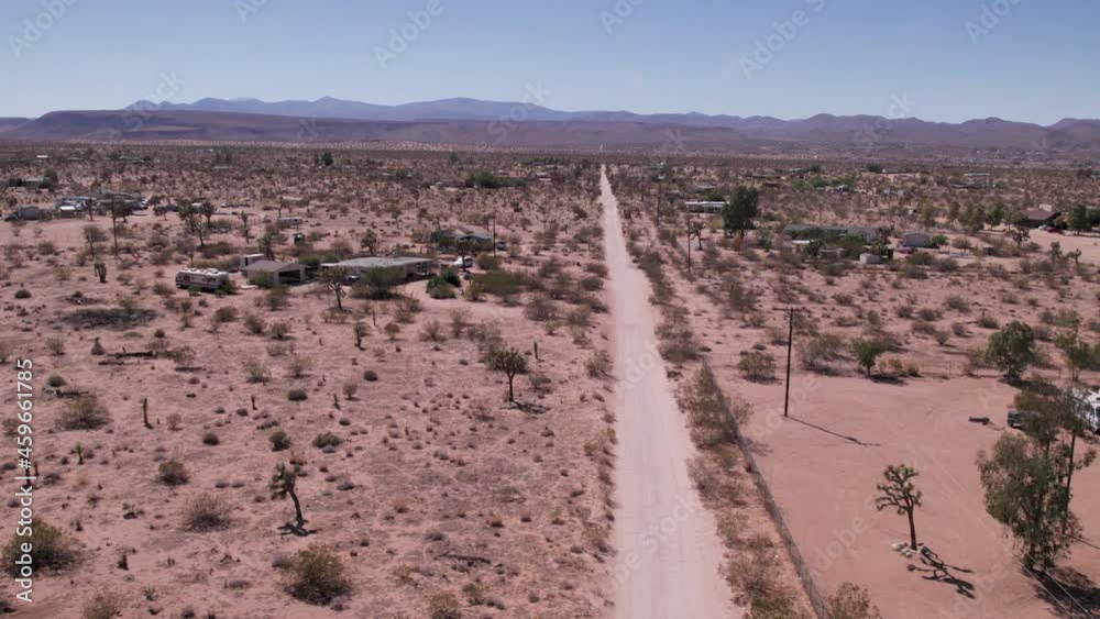 Joshua Tree California Dirt road with houses in desert. Aerial view - stock video Joshua Tree California Dirt road with houses in desert. Aerial view - stock video