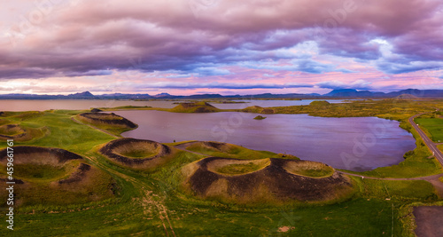 Aerial panoramic view of Myvatn, Iceland at epic sunset. Volcanic Craters In Green Plaints and link clouds and sky © Igor Tichonow