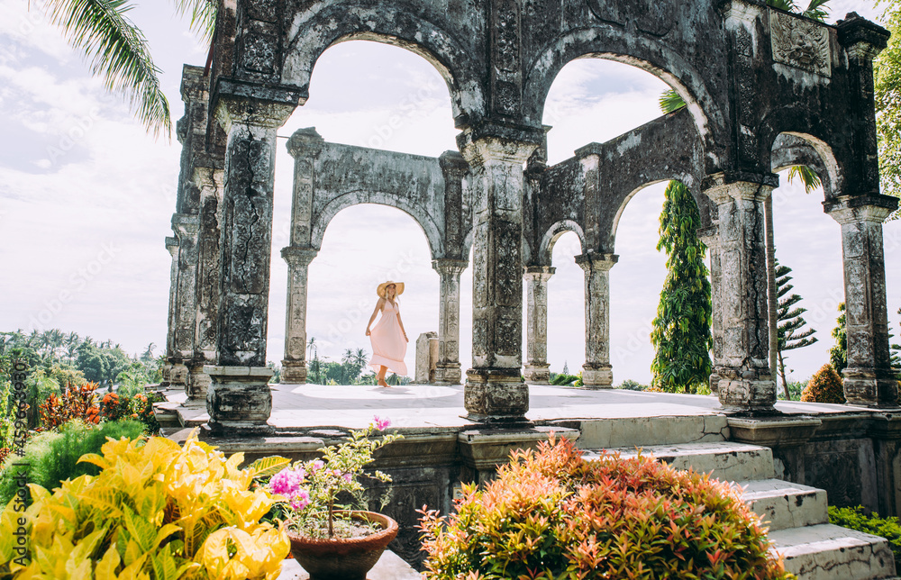 Fototapeta premium Beautiful caucasian girl visiting the water palace in Bali