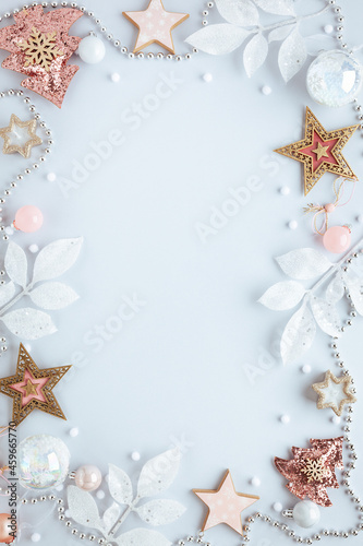 Christmas and New Year holidays frame. Christmas ornaments on light pastel background. Flat lay, copy space.