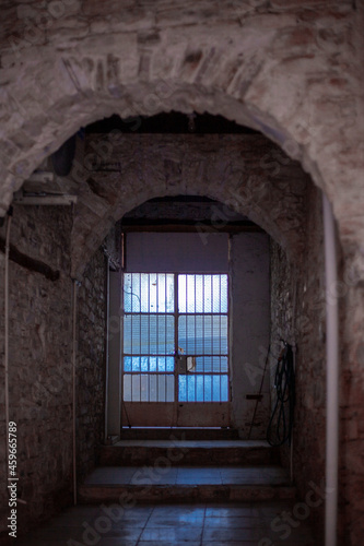 glass door at the end of stone passage