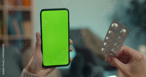 Woman using mobile with green sceen for medical consultation photo