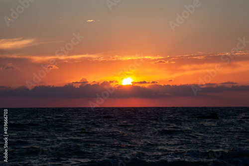 Sunset with huge sun falling on the sea at Aphrodite beach in Cyprus © Raquel