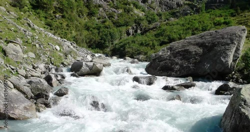 Rapid mountain river stream in the Swiss Alps Trift region. Real time, no people, summer sunny day. photo