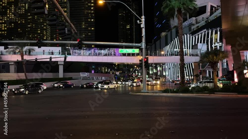Las Vegas Blvd Boulevard with cars driving by and turning on intersection in tourist city with hotels, gambling, casinos, clubs, and night life