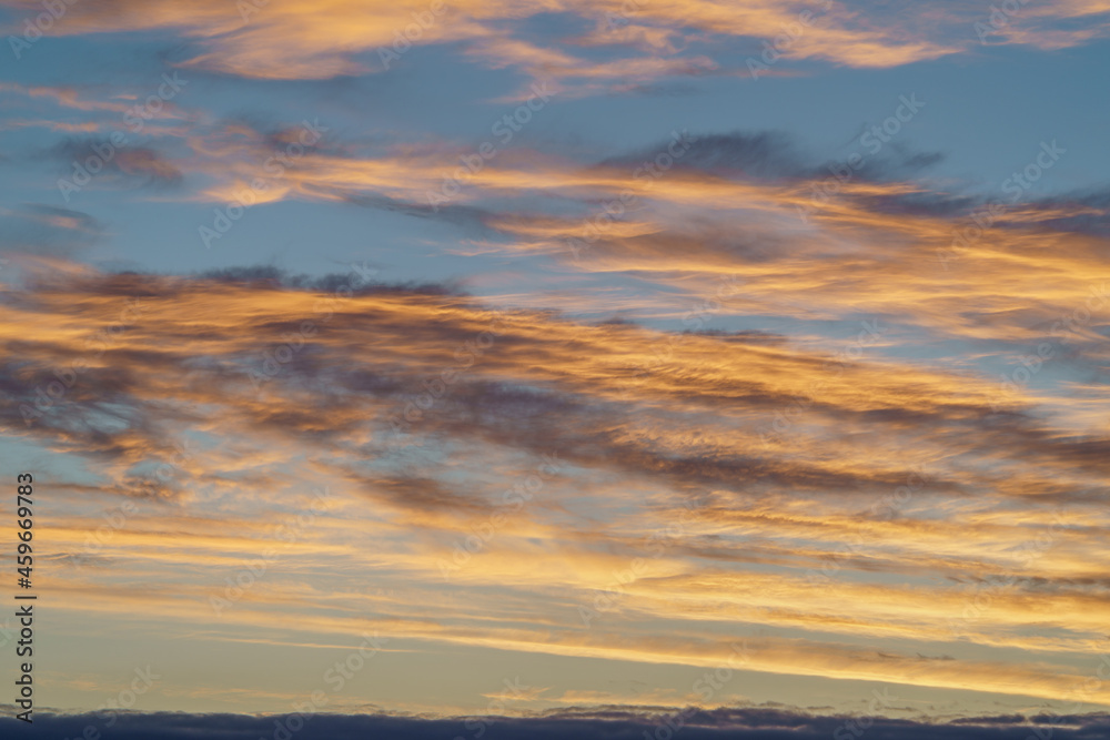 The dawn sky with clouds, yellow or blue shades. Beautiful natural background before sunrise or sunset.