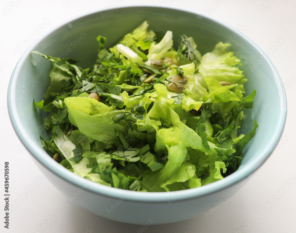 fresh salad leaves with pumpkin seeds in a plate, close-up. Comfortable digestion, proper nutrition, weight loss. The texture of vegetables, salad. Seasonal vitamins, fiber fresh salad leaves with pumpkin seeds in a plate, close-up. Comfortable digestion, proper nutrition, weight loss. The texture of vegetables, salad. Seasonal vitamins, fiber