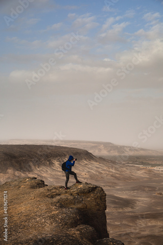 Photographer shooting landscape on top of a mountain.