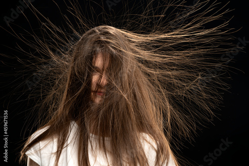 Woman with long static hair up, isolated on black background.  photo