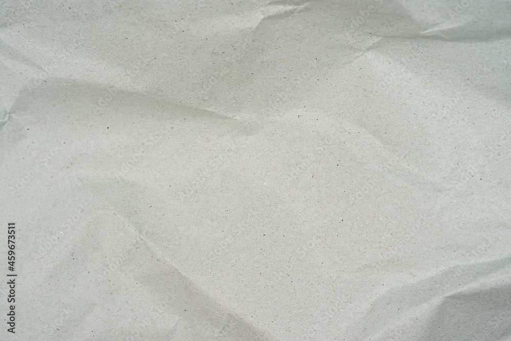 Fototapeta premium Natural recycled paper or paperwork closeup of wrinkle texture shiny work sheet.