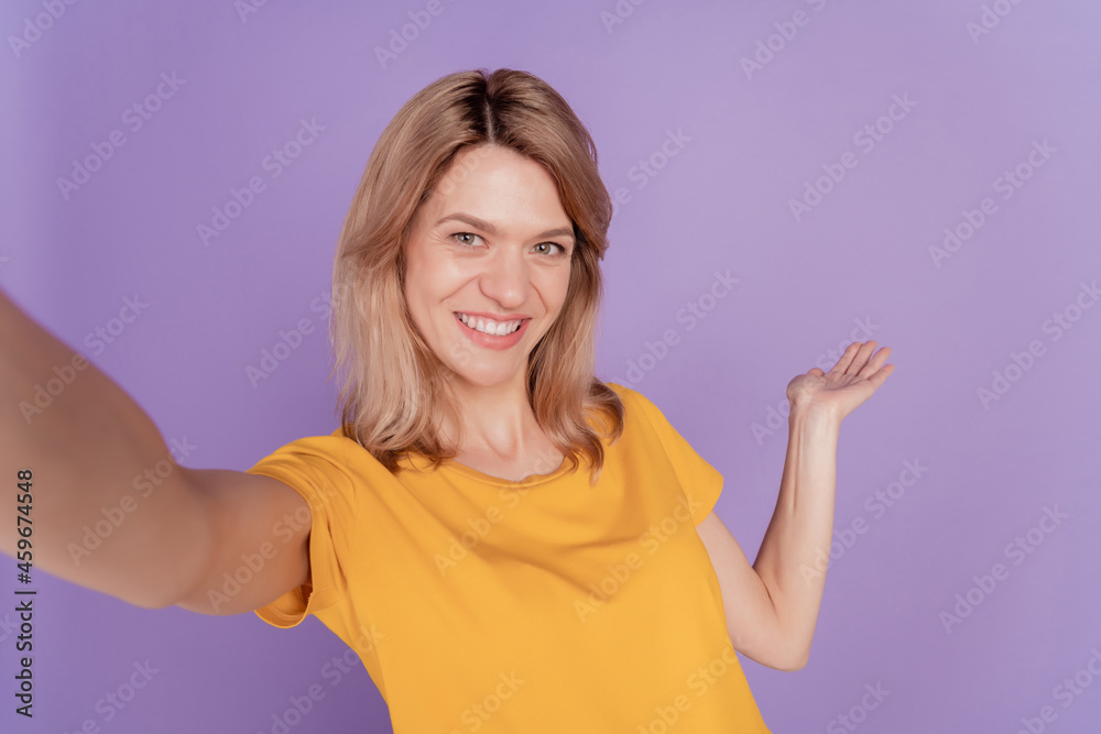 Close up photo beautiful woman happy positive smile make take selfie show welcome isolated over purple color background Close up photo beautiful woman happy positive smile make take selfie show welcome isolated over purple color background