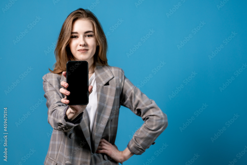 Girl showing phone in copyspace for designer. Girl showing phone in copyspace for designer.