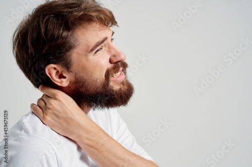 emotional man holding neck arthritis health problems light background
