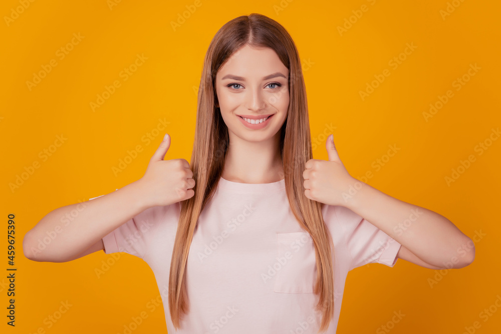 Portrait of charming reliable cute lady raise thumb up show agree gesture on yellow background Portrait of charming reliable cute lady raise thumb up show agree gesture on yellow background