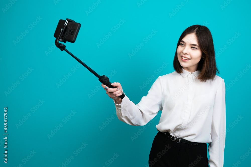 Asian girl takes pictures for social networks. Girl makes Asian girl takes pictures for social networks. Girl makes
