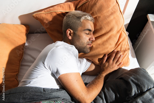 View from above of hispanic man sleeping in the morning photo