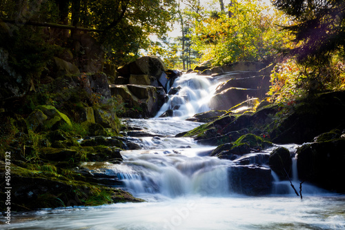 Long exposure shot of a beautiful waterfall in nature in the daylight photo