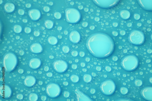 Blurred water drops on blue background texture
