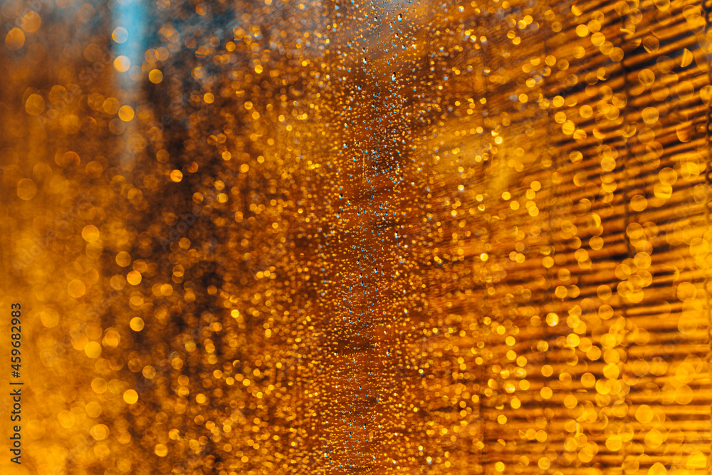 Golden rain drops background in dark time of day