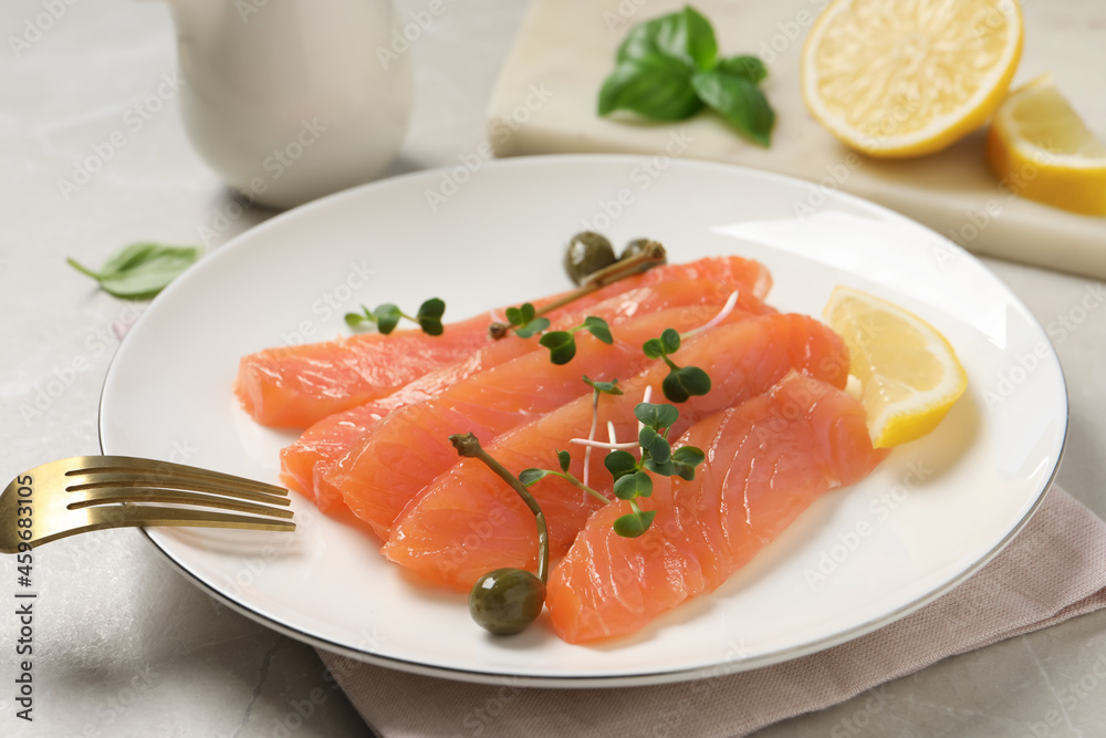 Delicious salmon carpaccio served on light grey table, closeup Delicious salmon carpaccio served on light grey table, closeup