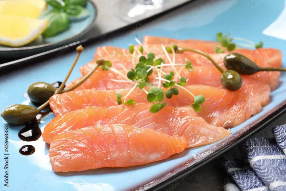 Delicious salmon carpaccio served on table, closeup Delicious salmon carpaccio served on table, closeup
