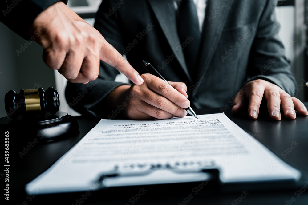Fototapeta premium Close up of businessmen or lawyers discussing contract or business agreement at law firm office, Business people making deal document legal, justice advice service concept.
