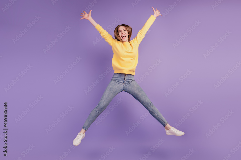Obraz premium Portrait of charming active energetic funny lady jump have fun on violet background