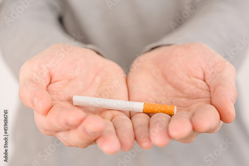 Man holds a cigarette in the palm of your hand. the concept