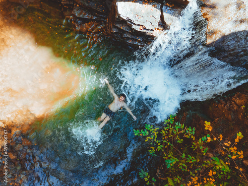 overhead view of man swimming in autumn waterfall © phpetrunina14