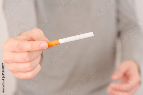 A man offers to smoke a cigarette. One cigarette is pulled
